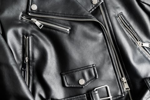 Close up of leather biker jacket fashion and stylish concept
